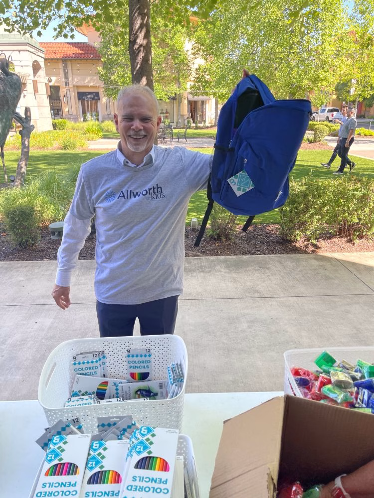 Adam is pictured here at a backpack stuffing event
