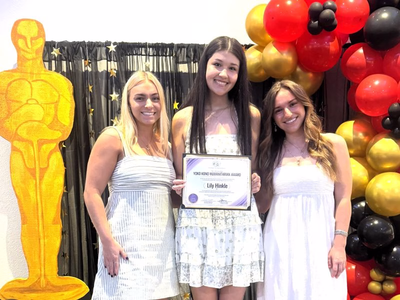 Megan and Taylor Smith present the inaugural Yoko Kono Humanitarian Award recipient at the 2026 Youth Recognition Event to Lily Hinkle.